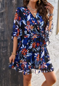 Close-up of V-neck floral chiffon dress with ruffled sleeves and tie waist detail