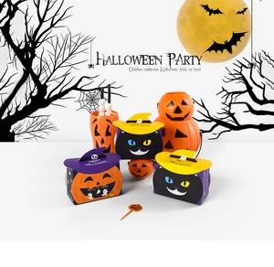 Detail view of pumpkin and black cat themed Halloween candy boxes and party containers
