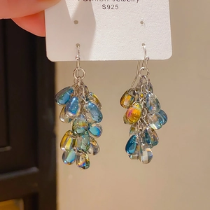Macro shot of S925 silver needle earrings with colorful gradient waterdrop glass beads