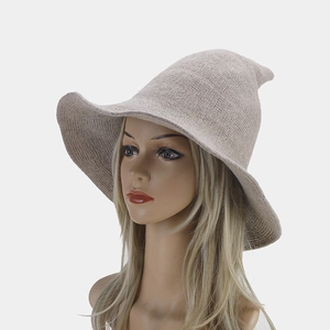 Detail of knitted pointed witch hat for women showing texture and wavy brim in beige