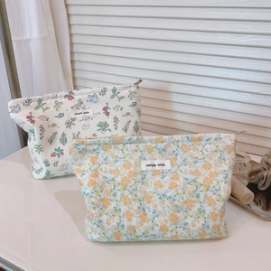 Floral and illustrated fabric makeup pouches with zip closure and simple wish logo tag