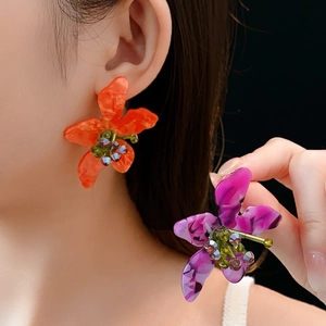 Detailed close-up of vintage flower earrings with purple resin petals and bead accents