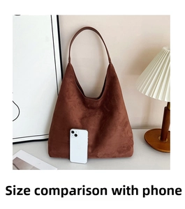 Brown faux suede tote bag size comparison with a white smartphone in a cozy setting