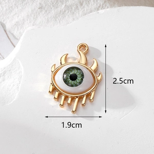 Detailed size view of a 2.5cm green evil eye pendant with gold plating on marble background
