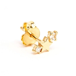 Macro shot of gold star earring with cubic zirconia stones and secure stud backing