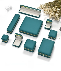 Deep green jewelry box with gold trim detail and special paper texture for luxury gifts