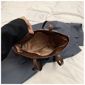 Top view of large brown tote bag showing zipper closure and spacious interior lining
