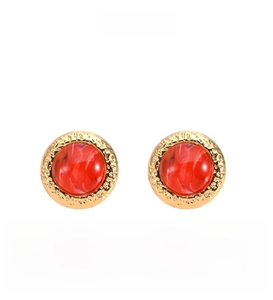 Detailed macro view of retro 18K gold-plated earrings with red gemstone and hammered texture