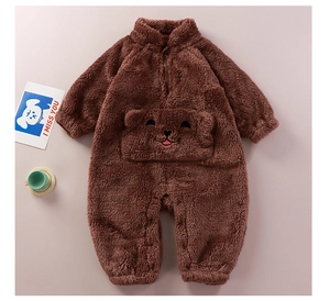 Detail of baby winter plush romper featuring a soft brown bear pocket and fleece texture