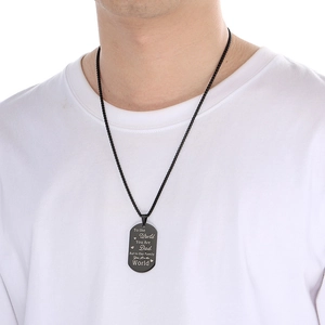 Close-up of black titanium steel military dog tag necklace with laser engraved message