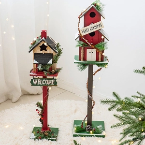 Wooden Christmas birdhouse decor with pine needles, berries and warm holiday lights