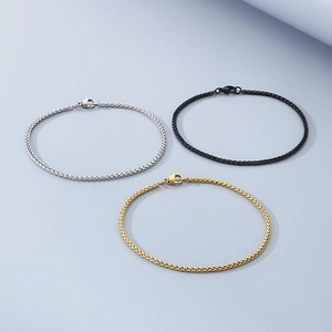 Close-up of stainless steel wheat chains in silver, black and gold with lobster clasps