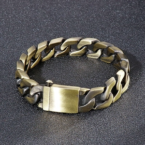 Detailed macro view of bronze-toned stainless steel Cuban link bracelet with square clasp