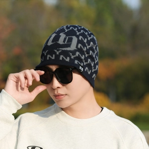 Navy blue winter knitted beanie with visor featuring grey NY pattern and fleece lining