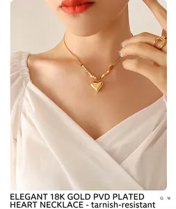 Close-up of golden heart pendant necklace with polished finish and block chain detail