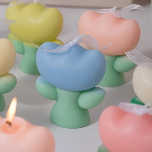 Detailed close-up of colorful tulip-shaped scented candles with soft romantic textures