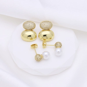 18k gold plated gourd earrings with zircon stones and white pearls on a minimalist stand