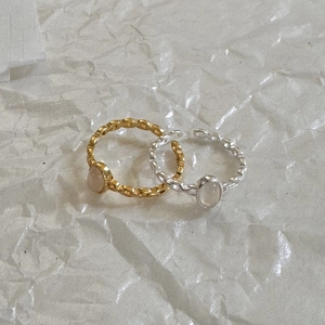 Detailed view of hammered S925 silver rings with oval white crystal in gold and silver