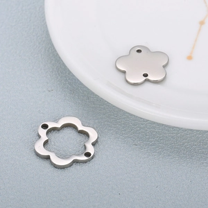 Detailed macro view of silver flower-shaped stainless steel jewelry connectors