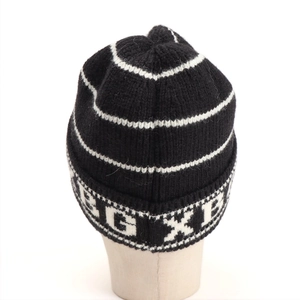 Close-up of the thick knitted texture and EGXB lettering on the striped beanie