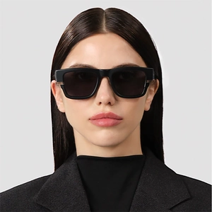 Close-up of model wearing black square oversized sunglasses with UV protection lenses