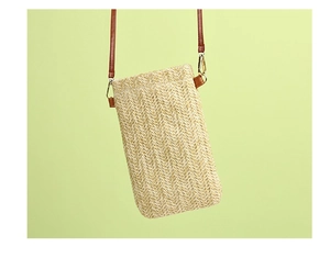 Detailed view of the wavy straw woven texture and brown PU leather strap with gold hooks