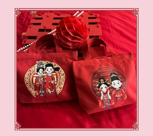 Detail of red bridal canvas gift bags with Double Xi symbol and pearl necklace accents