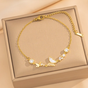 Elegant gold butterfly bracelet with white shell and zircon on jewelry box display