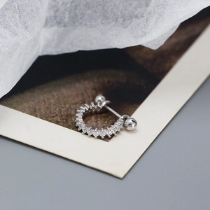 Macro view of s925 silver ear cuff with sparkling zircon crystals and screw-back closure