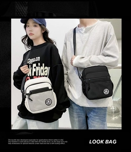 Detail view of adjustable straps and front mesh pocket on black and white crossbody bags