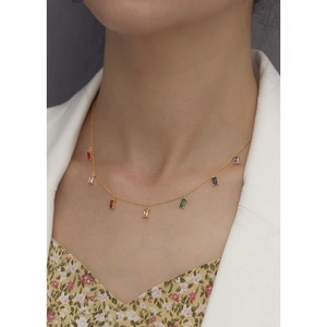 Detail of s925 silver necklace featuring colorful zircon stones on model's neckline