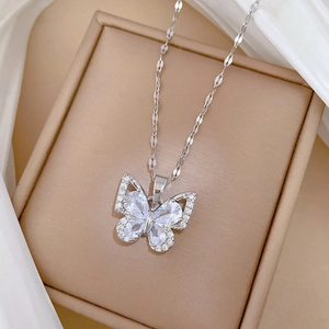 Close-up of butterfly necklace with zircon stones on a silk ribbon jewelry box
