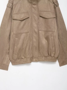 Detail of tan faux suede jacket showing utility pockets and elastic waist band