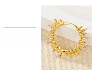 Detailed macro of S925 silver hoop earring with gold plating and sunburst beads
