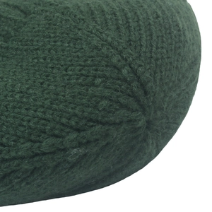 Macro detail of the dark green thick knit beanie top showing ribbed texture and stitching