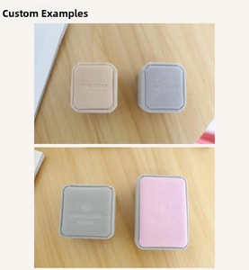 Detailed view of custom embossed logos on premium velvet jewelry gift boxes in various colors