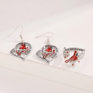 Detail of red cardinal heart earrings and open ring with enamel and engraved quotes