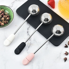 Three 304 stainless steel tea strainers with colorful silicone handles on a tray