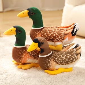 Three realistic mallard duck plush toys with green and brown feathers on soft carpet