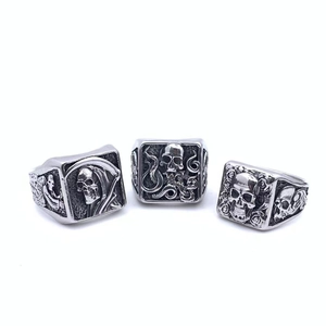 Gothic skull and reaper rose rings in vintage silver finish on white background
