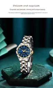 Detail view of two-tone women watch with blue dial and diamond accent on stone pedestal