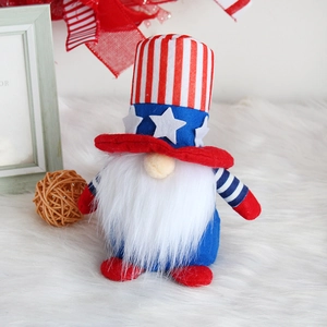 Independence Day gnome doll with red white and blue stars and stripes on fuzzy carpet