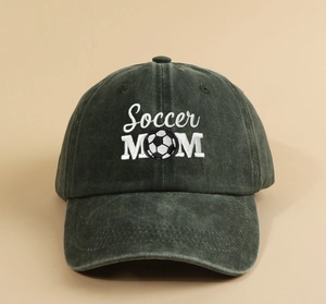Detailed close-up of white Soccer MOM embroidery and football pattern on green vintage cap