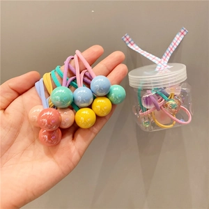 Jar of colorful elastic hair bands with beads for girls in pastel macaroon colors