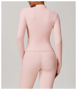 Rear view of pink long sleeve yoga jacket showing tight fit and elastic sports fabric
