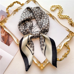 French vintage 70cm square silk scarf with floral print and black border on a gold tray