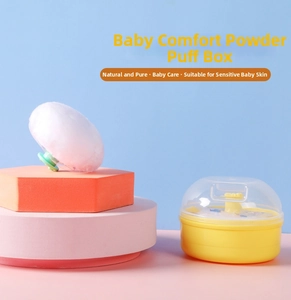 Detail of baby powder puff with green handle and yellow storage case on colorful stands