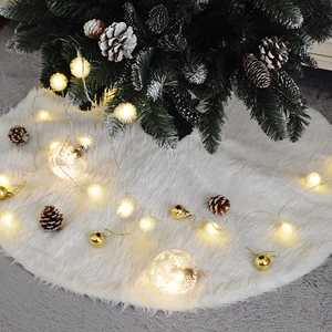 Plush white faux fur Christmas tree skirt with soft lighting and festive holiday ornaments