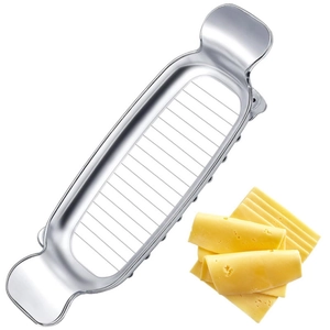 Macro shot of stainless steel cheese slicer with wire cutting through yellow cheese slices