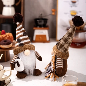 Close-up of coffee-themed Christmas gnomes with striped hats and plush white beards